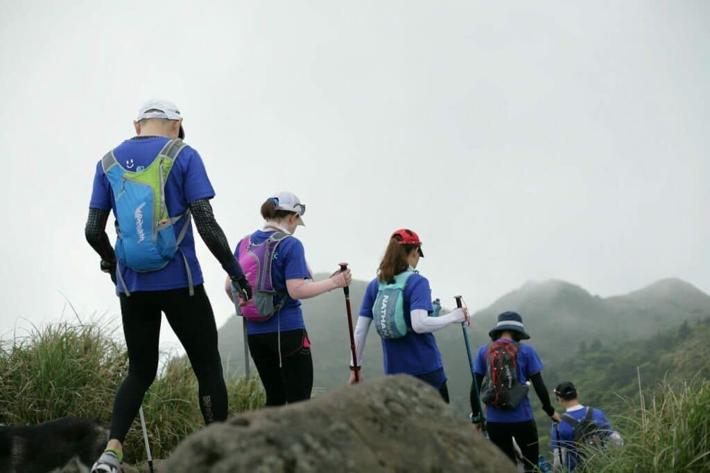 Photo by MChe Lee people standing on rock during daytime